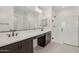 Modern bathroom featuring dual sinks, a walk-in shower and a large mirror at 1913 W Lariat Ln, Phoenix, AZ 85085