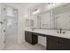 Bathroom with dual sinks and a view into an adjacent room with walk-in closet at 1913 W Lariat Ln, Phoenix, AZ 85085