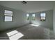 This is a bedroom with four windows and sunlight shining on the floor at 1913 W Lariat Ln, Phoenix, AZ 85085