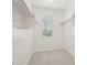 Walk-in closet with shelving units and a window letting in natural light at 1913 W Lariat Ln, Phoenix, AZ 85085