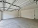 A garage with a concrete floor and white walls is shown in this listing image at 1913 W Lariat Ln, Phoenix, AZ 85085