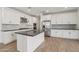 Bright kitchen features stainless appliances, gray counters, tile backsplash, and central island at 1913 W Lariat Ln, Phoenix, AZ 85085