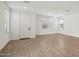 Spacious living room with wood-look tile flooring and ample natural light at 1913 W Lariat Ln, Phoenix, AZ 85085