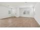 Spacious living room with wood-look tile flooring and ample natural light at 1913 W Lariat Ln, Phoenix, AZ 85085