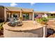Inviting backyard patio featuring decorative plants and a charming seating area, perfect for outdoor relaxation and entertainment at 20455 N Lemon Drop Dr, Maricopa, AZ 85138