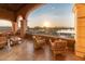 Enjoy stunning lake views from this covered balcony with comfortable seating; watch Arizona sunsets over the water at 20455 N Lemon Drop Dr, Maricopa, AZ 85138
