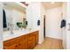 Bathroom featuring double sinks, wood cabinets, and tile floors at 20455 N Lemon Drop Dr, Maricopa, AZ 85138