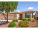 Charming single-story home with a well-maintained front yard, desert landscaping, and a two-car garage at 20455 N Lemon Drop Dr, Maricopa, AZ 85138
