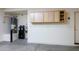Garage with water heater, water softener and storage cabinets at 20455 N Lemon Drop Dr, Maricopa, AZ 85138