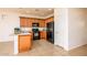 Well-equipped kitchen featuring light wood cabinets, black appliances, and tile flooring at 20455 N Lemon Drop Dr, Maricopa, AZ 85138