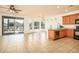 Open-concept living space with tile flooring, a sliding glass door to patio, and a breakfast bar at 20455 N Lemon Drop Dr, Maricopa, AZ 85138
