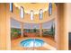 Indoor spa with mural, multiple windows, and columns, offers a relaxing amenity at 20455 N Lemon Drop Dr, Maricopa, AZ 85138