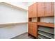Spacious walk-in closet with custom wood cabinets and shelves at 20455 N Lemon Drop Dr, Maricopa, AZ 85138