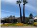Exterior view of a single-story home with mature landscaping and a covered parking area on a sunny day at 207 E Papago Dr, Tempe, AZ 85288