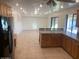 Open concept kitchen with wood cabinets, tiled floors, and a view to the living area with a sliding glass door at 207 E Papago Dr, Tempe, AZ 85288