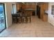 A spacious kitchen features wooden cabinets, a tiled floor, and a long center island with bar stool seating at 207 E Papago Dr, Tempe, AZ 85288