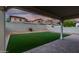 Backyard featuring green turf, a brick paver patio, and a block wall for privacy at 20866 W Hamilton St, Buckeye, AZ 85396