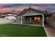 View of backyard featuring green turf, a brick paver patio, and a block wall for privacy at 20866 W Hamilton St, Buckeye, AZ 85396