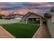 Twilight view of backyard featuring artificial turf, a covered patio, and an exterior wall at 20866 W Hamilton St, Buckeye, AZ 85396