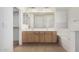 Bathroom with a double sink vanity, bathtub and shower combo, and large mirror at 20866 W Hamilton St, Buckeye, AZ 85396