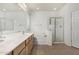 Spacious bathroom featuring a double sink vanity, separate tub, and a walk-in shower at 20866 W Hamilton St, Buckeye, AZ 85396