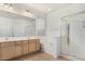 Bright bathroom with double sinks, soaking tub, and glass-enclosed shower at 20866 W Hamilton St, Buckeye, AZ 85396