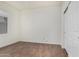 Bright bedroom featuring wood-look tile flooring, a window, and a closet with sliding doors at 20866 W Hamilton St, Buckeye, AZ 85396