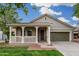 Charming single-story home featuring a welcoming front porch and well-manicured lawn at 20866 W Hamilton St, Buckeye, AZ 85396