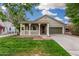 Attractive single-story home showcasing a delightful front porch and green lawn at 20866 W Hamilton St, Buckeye, AZ 85396