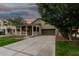 Cozy single-story home with a charming front porch and a long driveway at dusk at 20866 W Hamilton St, Buckeye, AZ 85396