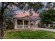 Inviting single-story home featuring a charming front porch and lush green lawn at dusk at 20866 W Hamilton St, Buckeye, AZ 85396