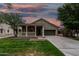 Beautiful single-story home showcasing a delightful front porch under a colorful dusk sky at 20866 W Hamilton St, Buckeye, AZ 85396