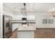 Well-lit kitchen featuring white cabinets, stainless steel appliances, and a large island with a sink at 20866 W Hamilton St, Buckeye, AZ 85396