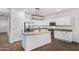 Contemporary kitchen with white cabinetry, stainless steel appliances, and a stylish island with a sink at 20866 W Hamilton St, Buckeye, AZ 85396