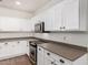 Bright kitchen with white cabinetry, stainless steel appliances, and ample counter space for meal preparation at 20866 W Hamilton St, Buckeye, AZ 85396