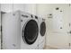 Bright laundry room with modern LG washer and dryer and tan tile flooring at 20866 W Hamilton St, Buckeye, AZ 85396