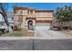 Charming two-story home featuring a well-manicured front yard, garage, and decorative entrance at 2109 S Luther --, Mesa, AZ 85209