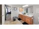 Well-lit bathroom featuring double sink vanity, large mirror, and access to the bedroom at 2109 S Luther --, Mesa, AZ 85209