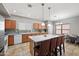 Charming kitchen boasts an island with seating, tile flooring, wood cabinetry and modern appliances at 2109 S Luther --, Mesa, AZ 85209