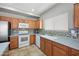 Traditional kitchen with wood cabinets, white appliances, tiled floors, and tiled backsplash at 2109 S Luther --, Mesa, AZ 85209