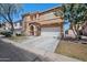 Inviting two-story home showcasing a manicured front yard, well-maintained landscaping, and attached garage at 2109 S Luther --, Mesa, AZ 85209