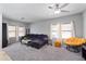 Cozy living room featuring a sectional sofa, ceiling fan, and bright natural light at 2109 S Luther --, Mesa, AZ 85209