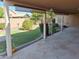 Covered back patio with stone flooring and views of the private yard and landscaping at 2434 S Colleen --, Mesa, AZ 85210