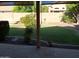 Manicured backyard with lush green grass, bushes, and stone patio at 2434 S Colleen --, Mesa, AZ 85210