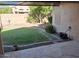 Manicured backyard with lush green grass, bushes, and stone patio at 2434 S Colleen --, Mesa, AZ 85210