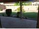 Manicured backyard with lush green grass, bushes, and stone patio at 2434 S Colleen --, Mesa, AZ 85210