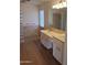 Bathroom showcasing dual sinks, wood-look floors, and a bright glass block shower at 2434 S Colleen --, Mesa, AZ 85210