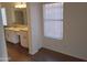Bathroom featuring dual sinks, wood-look floors, and a glass block shower at 2434 S Colleen --, Mesa, AZ 85210