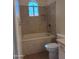 Tiled bathroom with tub and shower combination and natural lighting through a stylish, arched window at 2434 S Colleen --, Mesa, AZ 85210