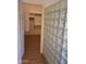 Bathroom featuring stylish glass block window and access to closet with custom shelving at 2434 S Colleen --, Mesa, AZ 85210